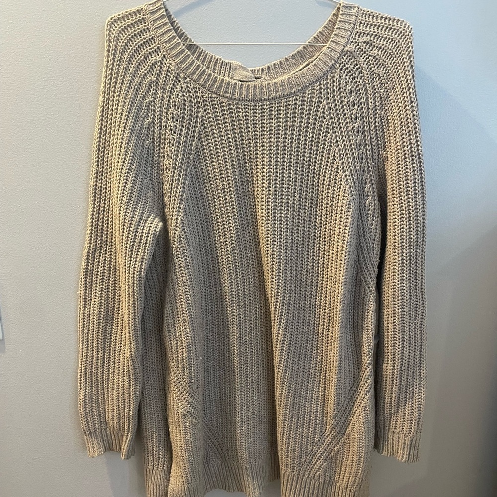 Oversized tan sweater with braided detail in the back.
